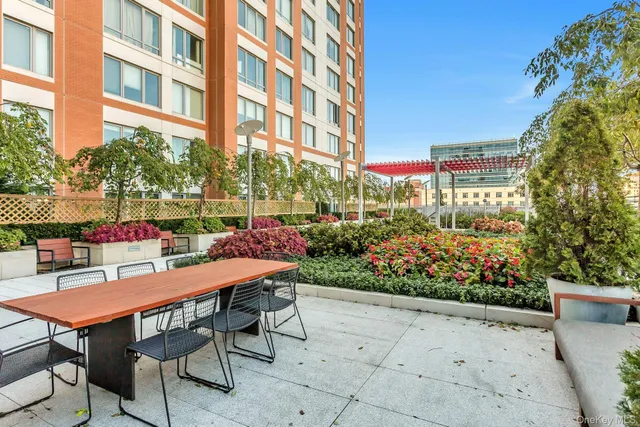 a view of a chairs and table in a backyard