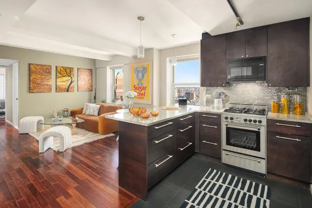 a kitchen with a sink stove and cabinets