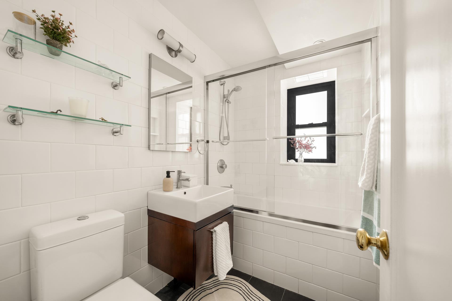 111 Hicks Street, Unit 22G Brooklyn, NY 11201 - Photo 11 of 17 a bathroom with a sink toilet and shower
