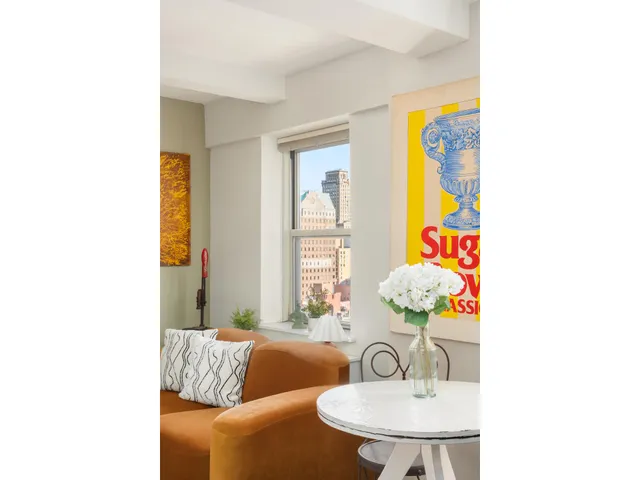 a living room with furniture and kitchen view