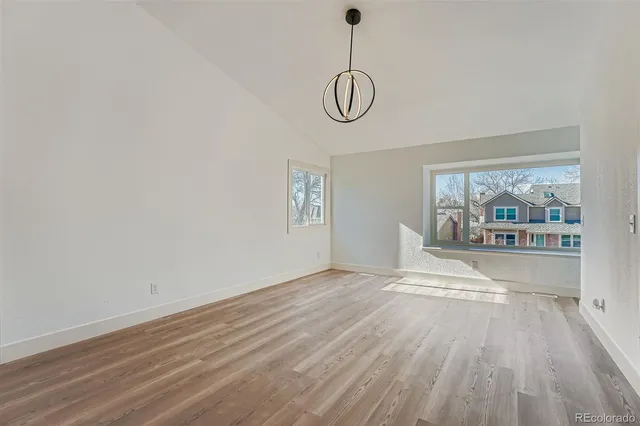 a view of a room with wooden floor and window