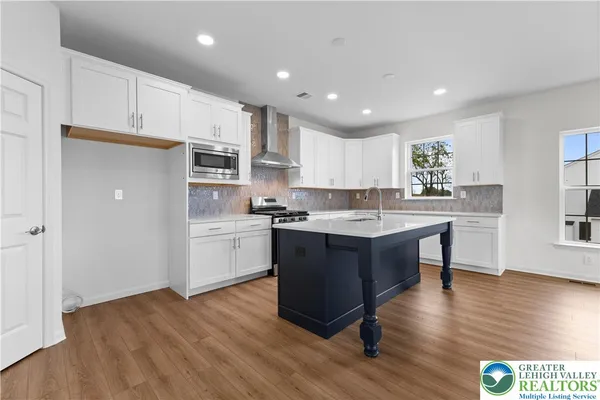 a kitchen with a sink cabinets and wooden floor