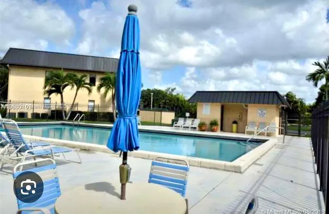 a view of swimming pool with a patio