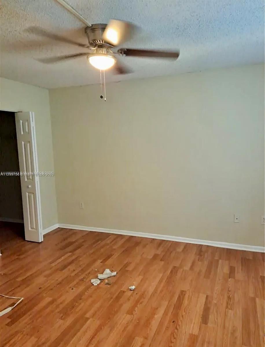 9317 Northwest 1st Court, Unit 105 Pembroke Pines, FL 33024 - Photo 11 of 25 a view of empty room with wooden floor