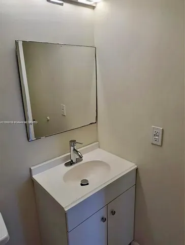 a bathroom with a sink and mirror