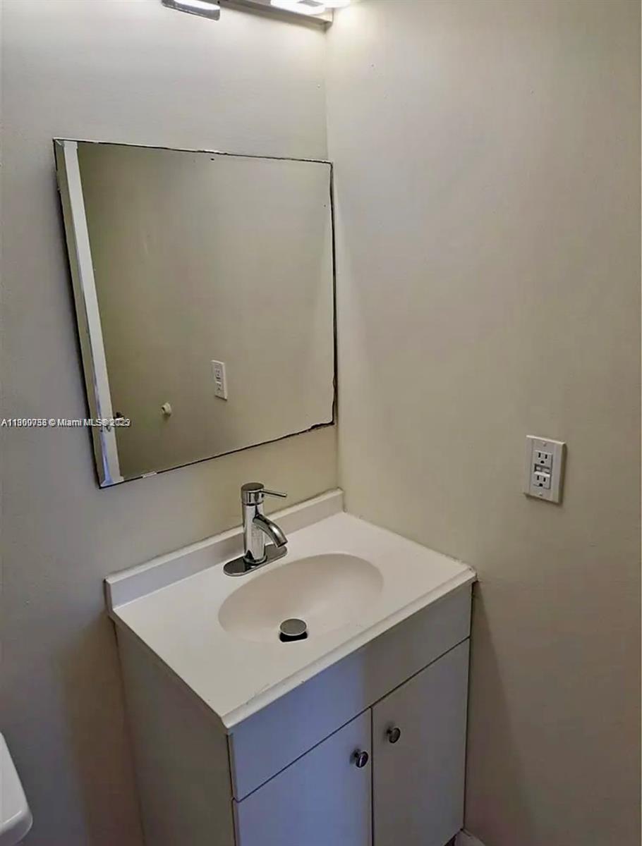 9317 Northwest 1st Court, Unit 105 Pembroke Pines, FL 33024 - Photo 15 of 25 a bathroom with a sink and mirror