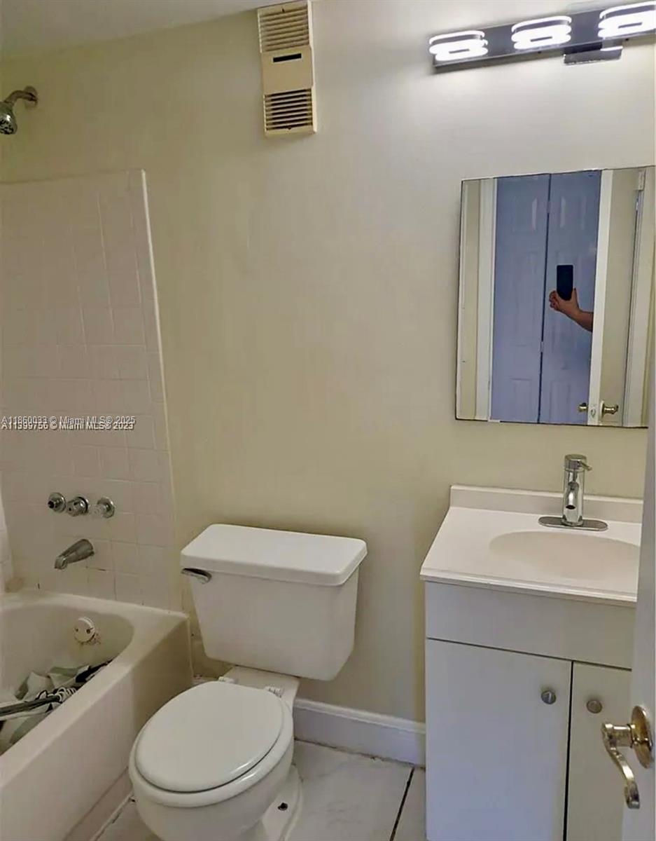 9317 Northwest 1st Court, Unit 105 Pembroke Pines, FL 33024 - Photo 16 of 25 a white toilet sitting next to a bathroom sink