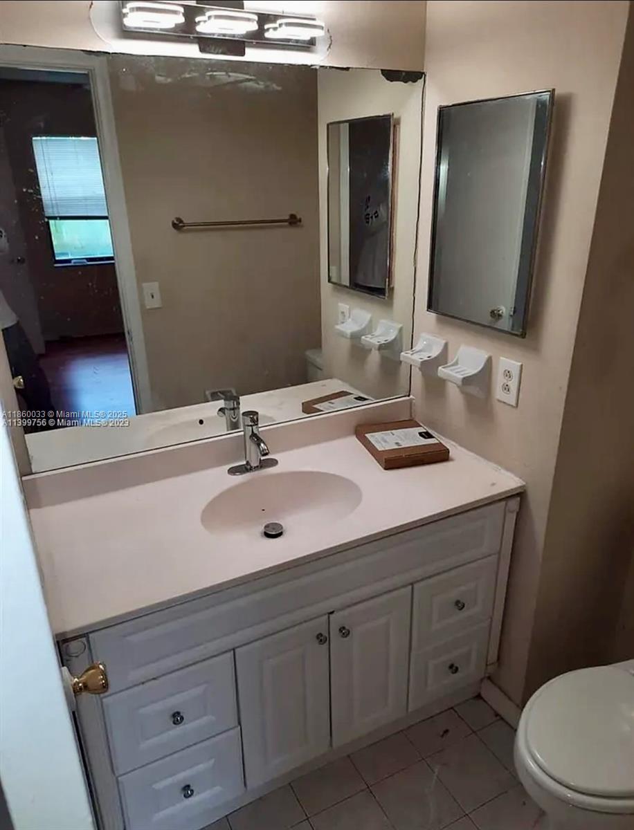 9317 Northwest 1st Court, Unit 105 Pembroke Pines, FL 33024 - Photo 18 of 25 a bathroom with a sink and a mirror