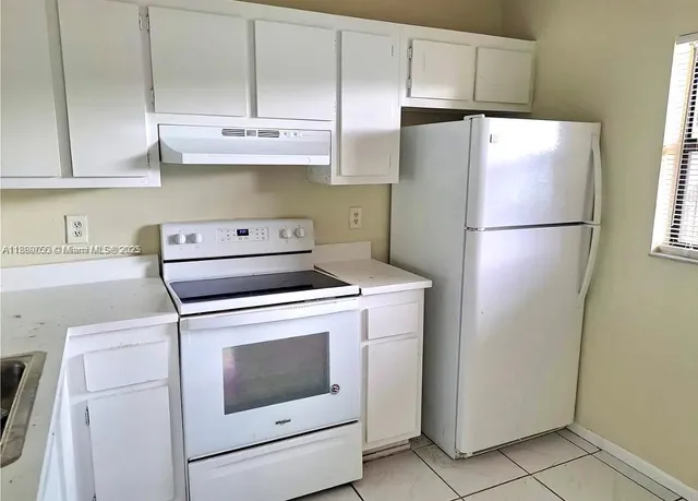 a white refrigerator freezer sitting inside of a kitchen