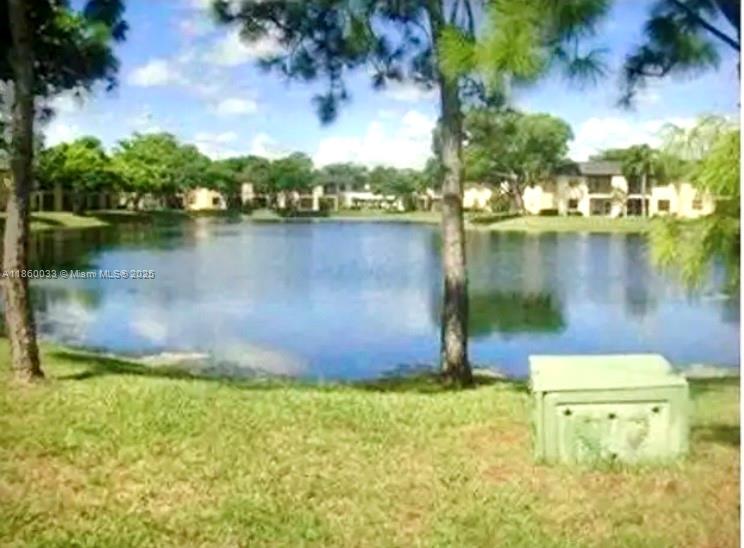 9317 Northwest 1st Court, Unit 105 Pembroke Pines, FL 33024 - Photo 5 of 25 a view of a lake with houses