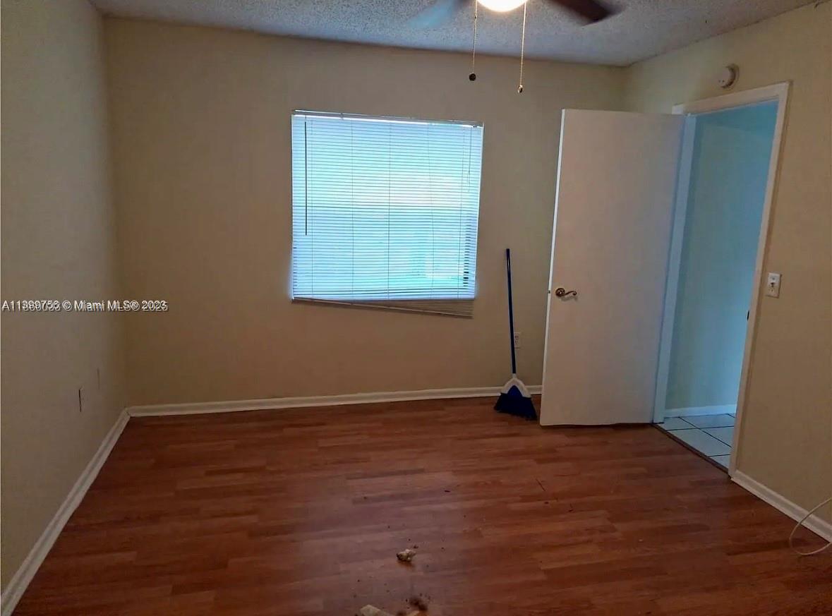 9317 Northwest 1st Court, Unit 105 Pembroke Pines, FL 33024 - Photo 9 of 25 an empty room with wooden floor closet and windows