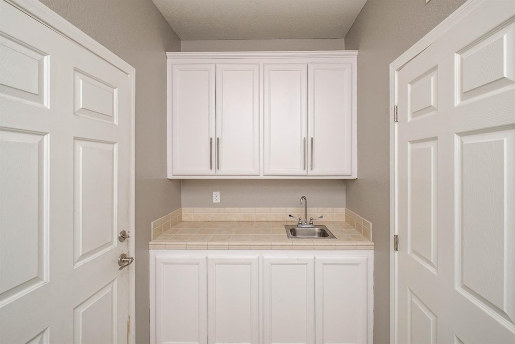 39405 Mountain View Road Yermo, CA 92398 - Photo 21 of 33 a kitchen with stainless steel appliances granite countertop white cabinets sink and window