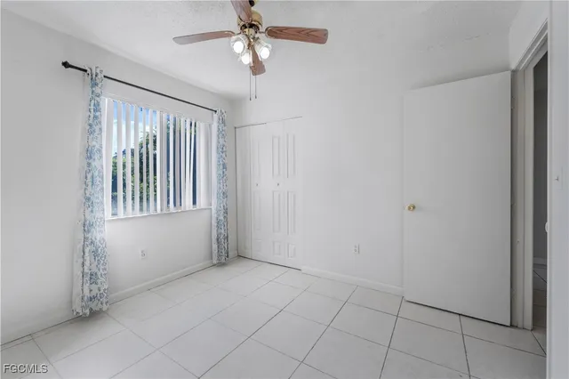 a view of an empty room with a fan