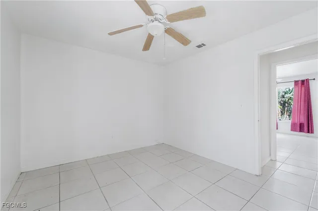 a view of entryway with stairs and a chandelier fan