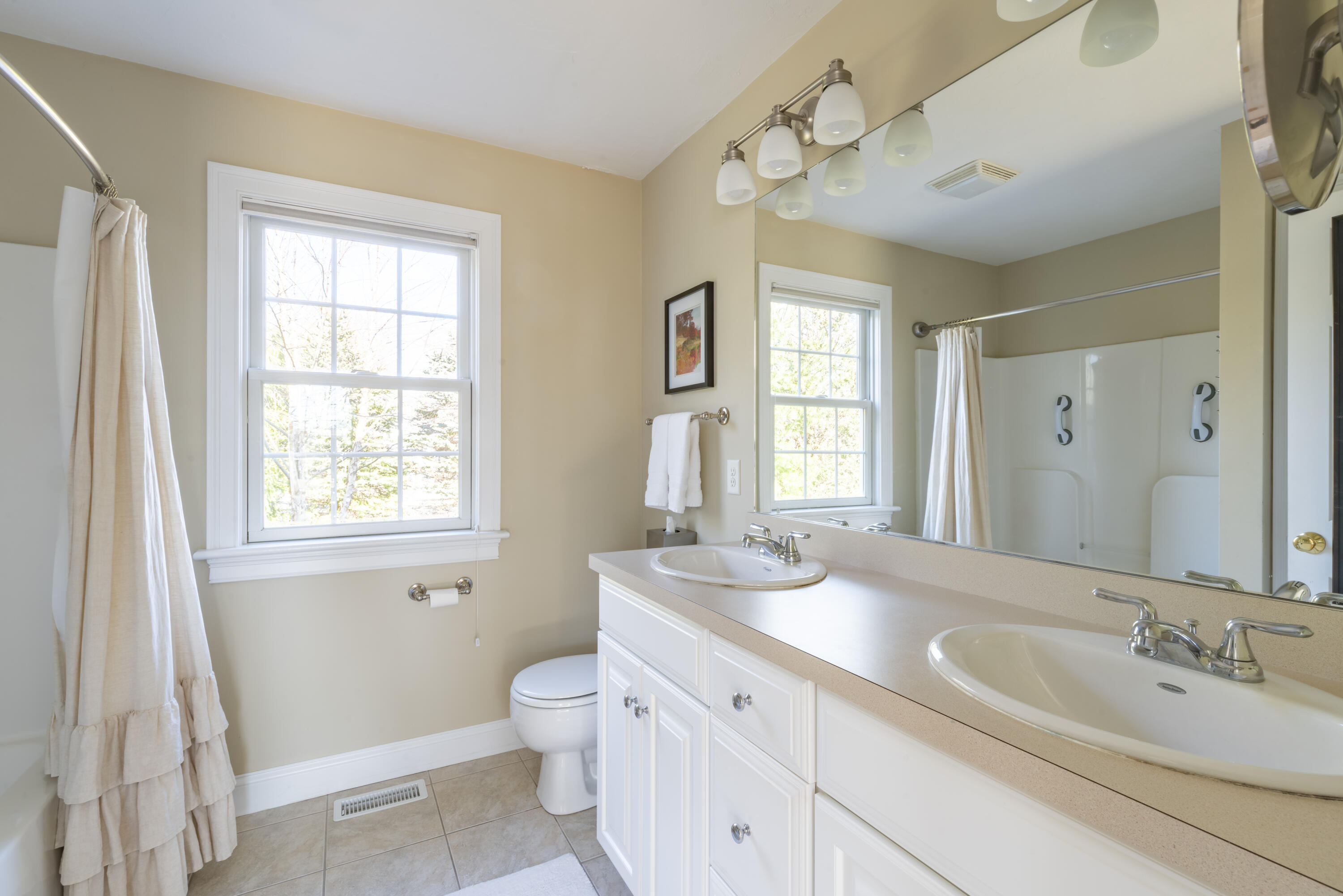 2 Parallel Street Harwich, MA 02645 - Photo 19 of 40 a spacious bathroom with a double vanity sink a mirror and a bathtub