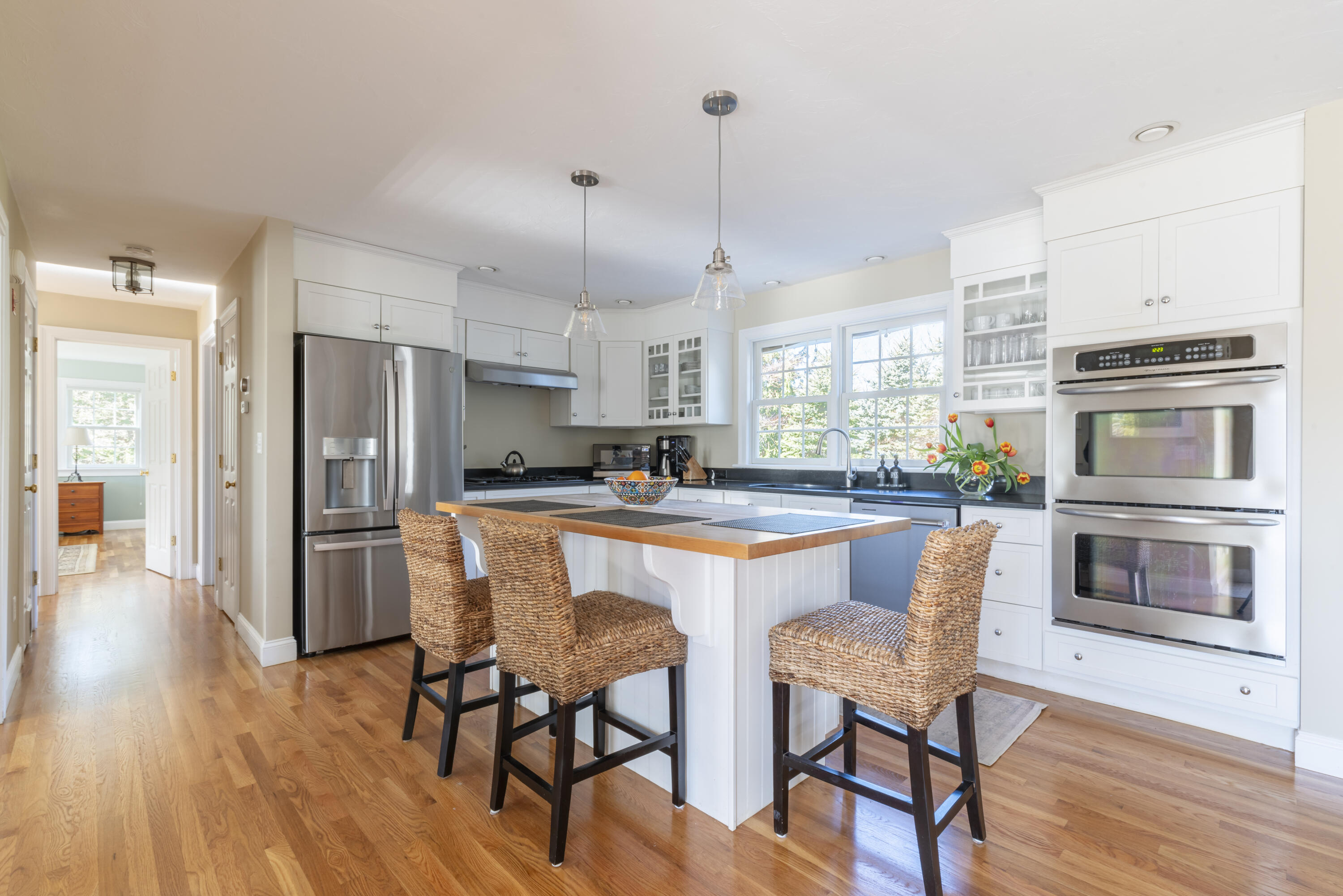 2 Parallel Street Harwich, MA 02645 - Photo 6 of 40 a kitchen with stainless steel appliances granite countertop a stove a refrigerator a oven a sink a dining table and chairs with wooden floor