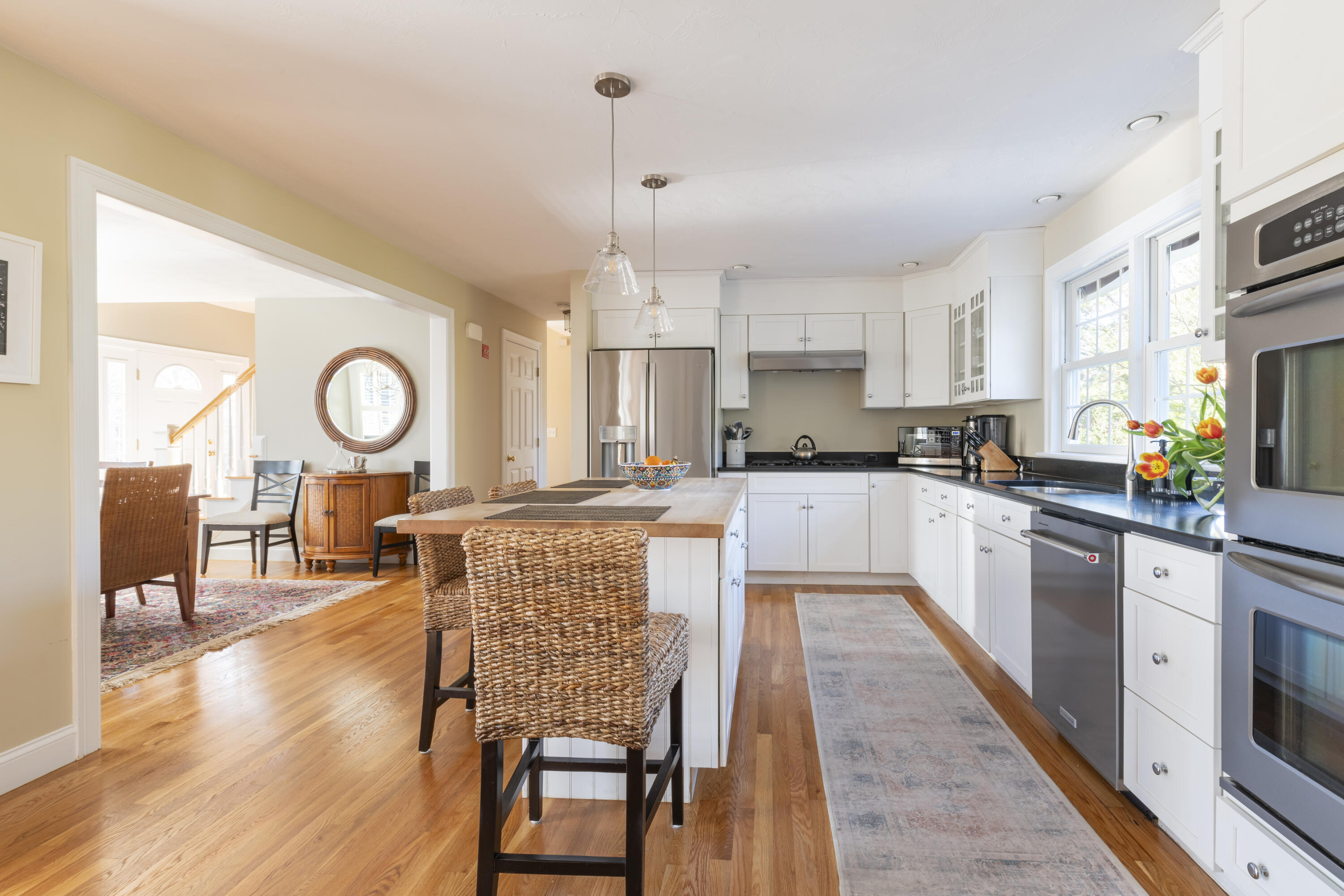 2 Parallel Street Harwich, MA 02645 - Photo 10 of 40 a large kitchen with cabinets wooden floor stainless steel appliances and dining table