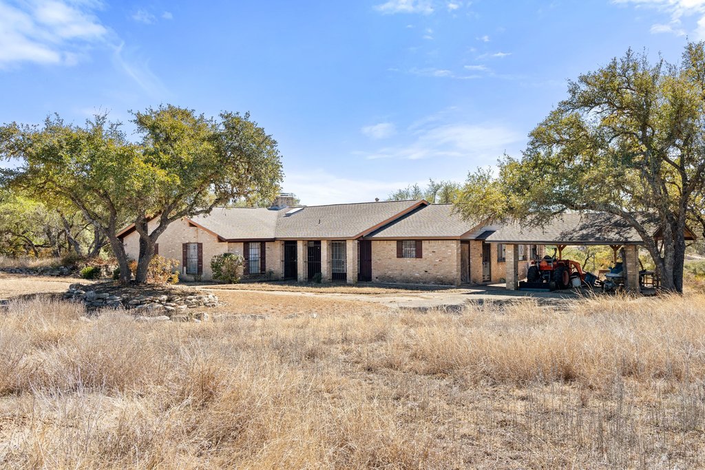 10904 Rawhide Trail Austin, TX 78736 - Photo 18 of 37 a front view of a house with a yard covered in snow
