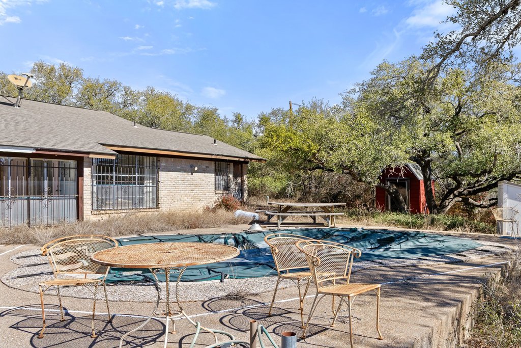 10904 Rawhide Trail Austin, TX 78736 - Photo 33 of 37 a backyard of a house with table and chairs
