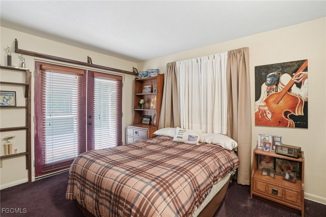 5541 Winkler Road Fort Myers, FL 33919 - Photo 17 of 22 a bedroom with a bed and a window