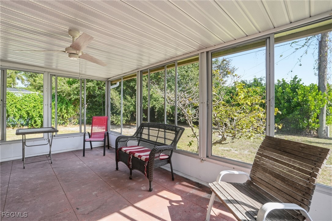 5541 Winkler Road Fort Myers, FL 33919 - Photo 19 of 22 a living room with furniture and a floor to ceiling window