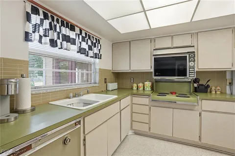 a kitchen with a sink cabinets and window