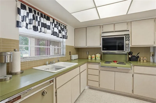 a kitchen with a sink cabinets and window
