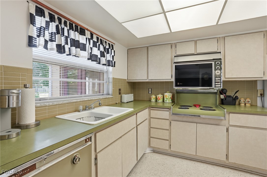 5541 Winkler Road Fort Myers, FL 33919 - Photo 6 of 22 a kitchen with a sink cabinets and window