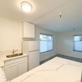 a kitchen with a refrigerator and window