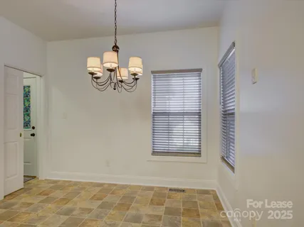 a view of a room with windows and a chandelier