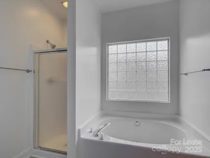 a white bath tub sitting next to a window