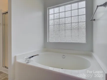 a white bath tub sitting next to a window