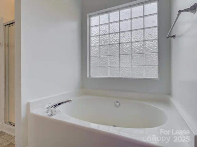 a white bath tub sitting next to a window
