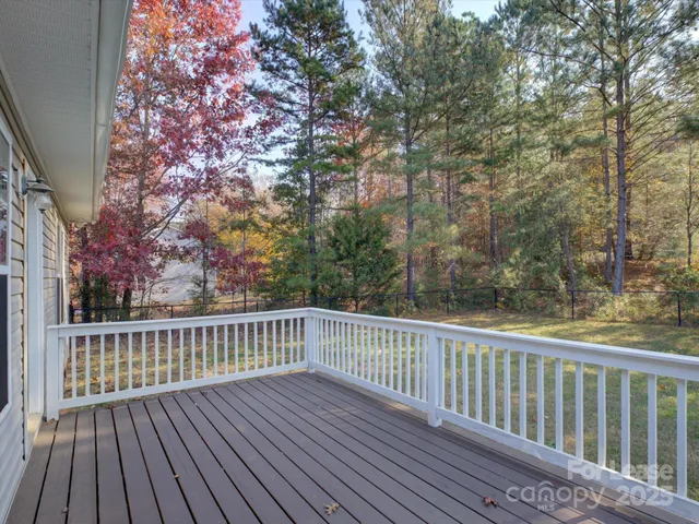a view of deck with wooden floor and fence