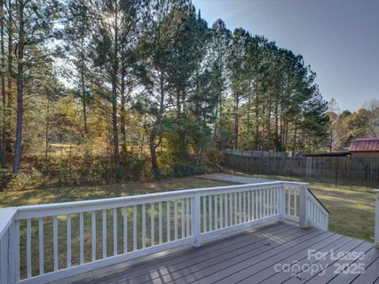 a view of balcony with wooden floor and fence