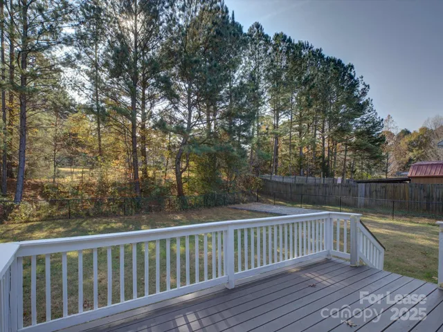 a view of balcony with wooden floor and fence