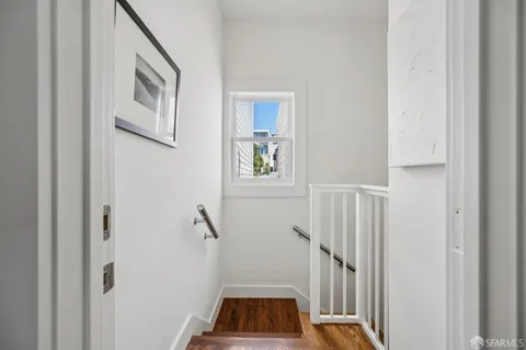 a kitchen with stainless steel appliances a stove a sink a refrigerator a center island cabinets and furniture