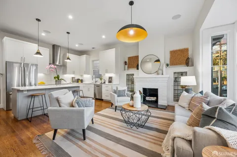 a kitchen with stainless steel appliances a sink a table and chairs
