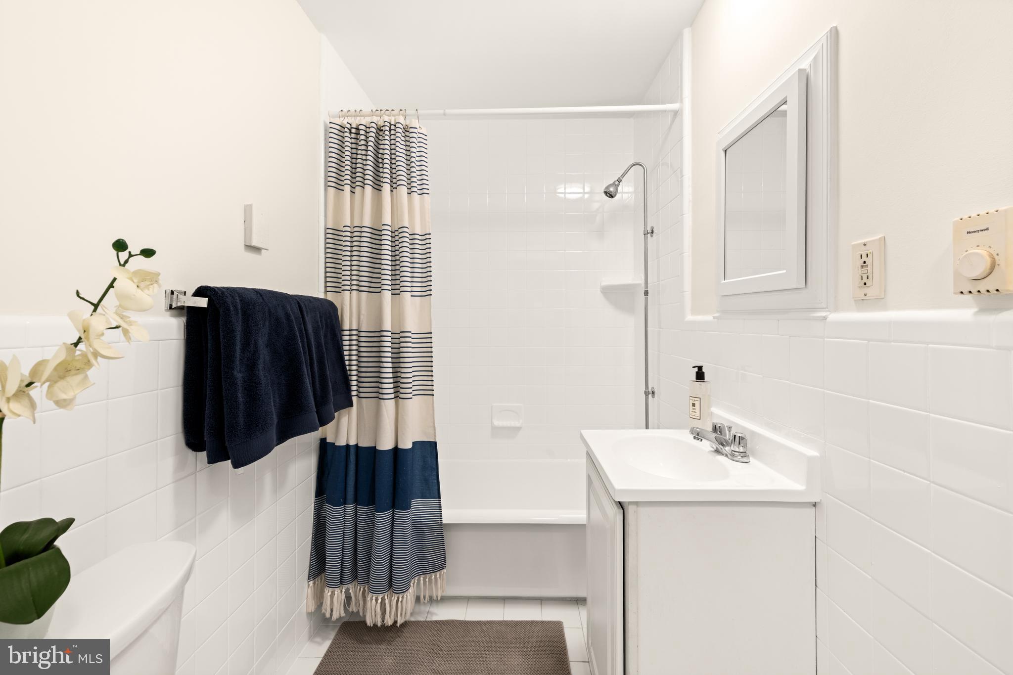 3446 Connecticut Avenue Northwest, Unit 401 Washington, DC 20008 - Photo 14 of 35 a bathroom with a sink and mirror
