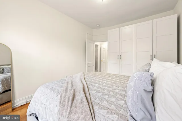 a bedroom with a bed and a mirror