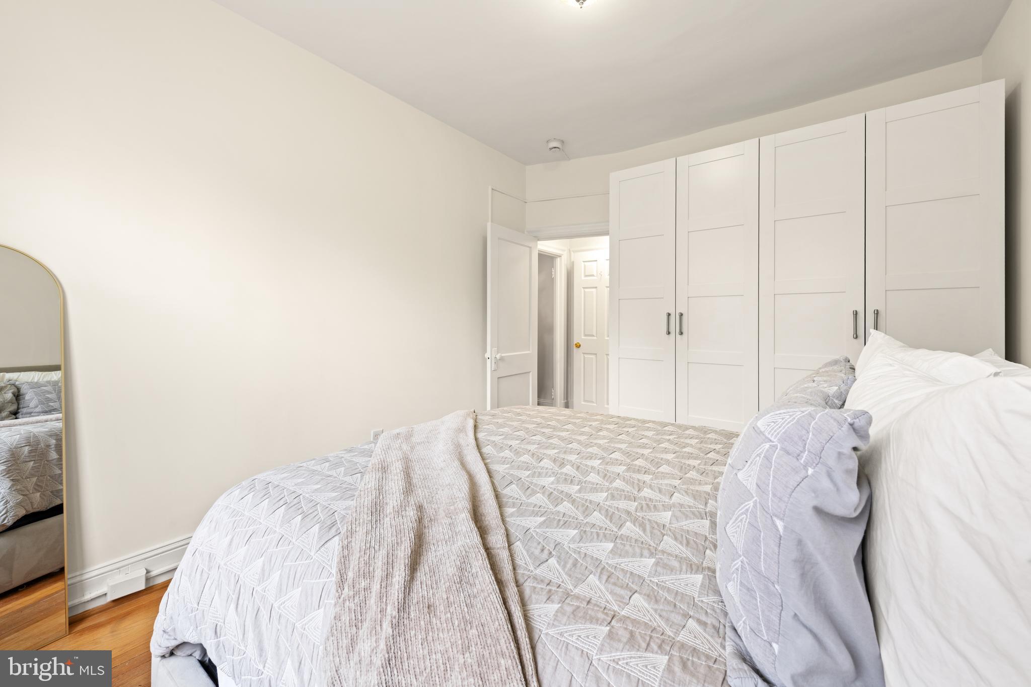 3446 Connecticut Avenue Northwest, Unit 401 Washington, DC 20008 - Photo 17 of 35 a bedroom with a bed and a mirror