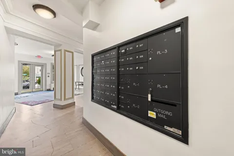 a view of staircase with railing and white walls