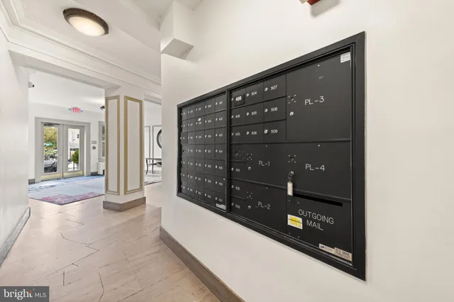 a view of staircase with railing and white walls