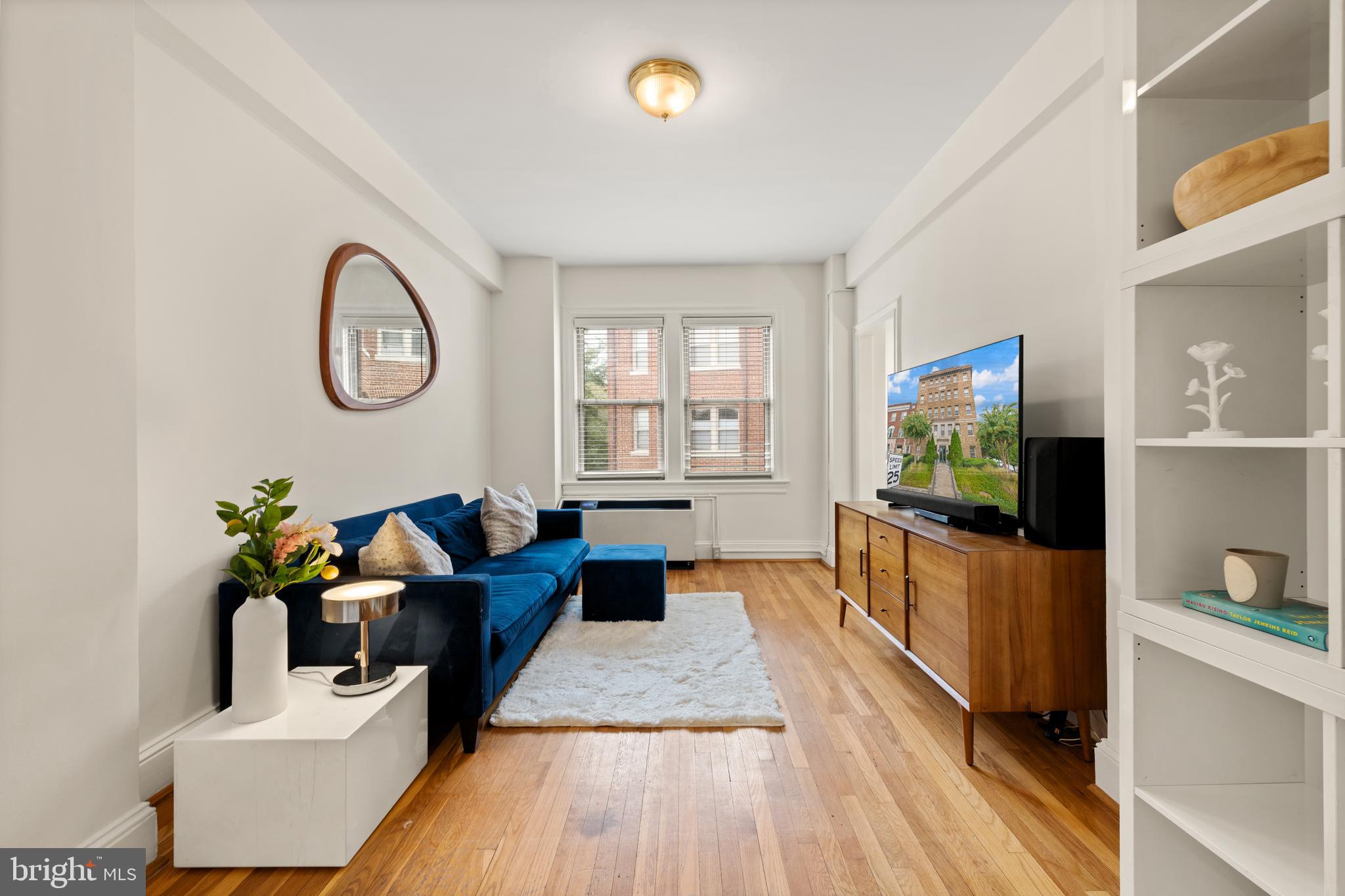 3446 Connecticut Avenue Northwest, Unit 401 Washington, DC 20008 - Photo 3 of 35 a living room with furniture and a flat screen tv