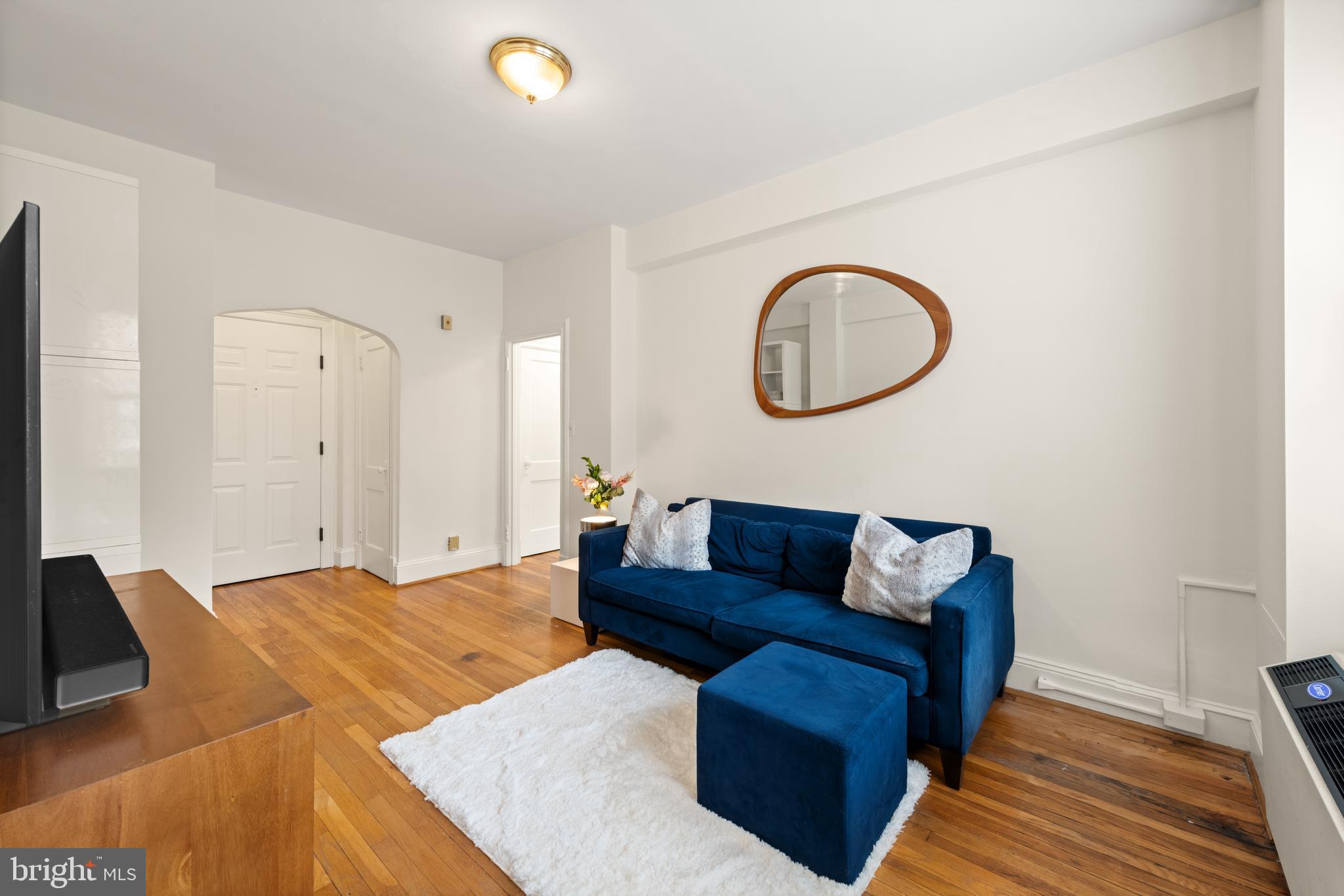 3446 Connecticut Avenue Northwest, Unit 401 Washington, DC 20008 - Photo 5 of 35 a living room with furniture and a wooden floor