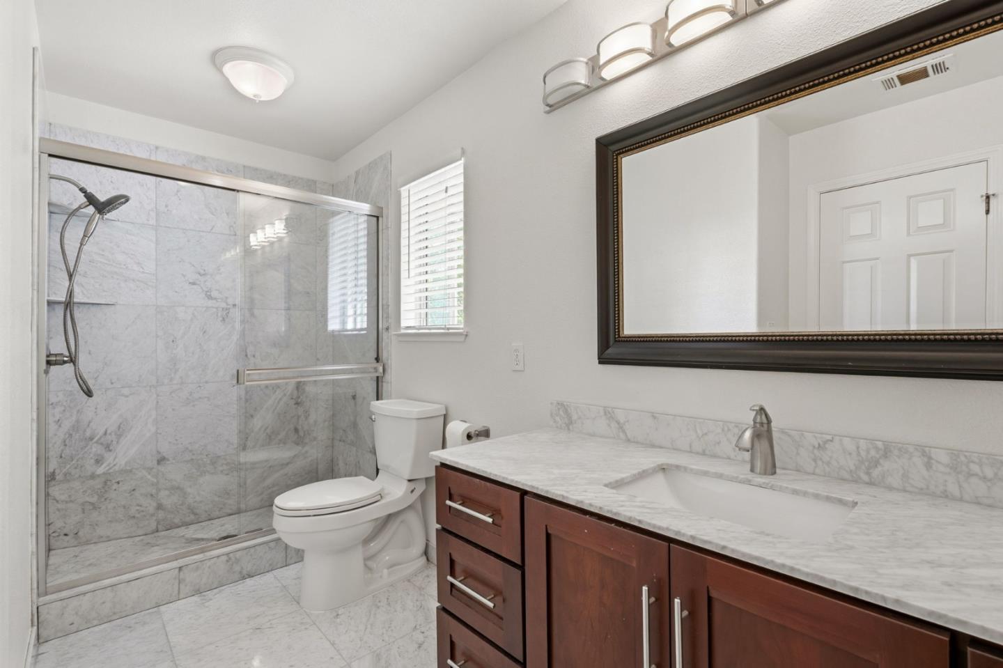 35 Sierra Ridge Court Danville, CA 94506 - Photo 34 of 37 a bathroom with a granite countertop sink a toilet and shower
