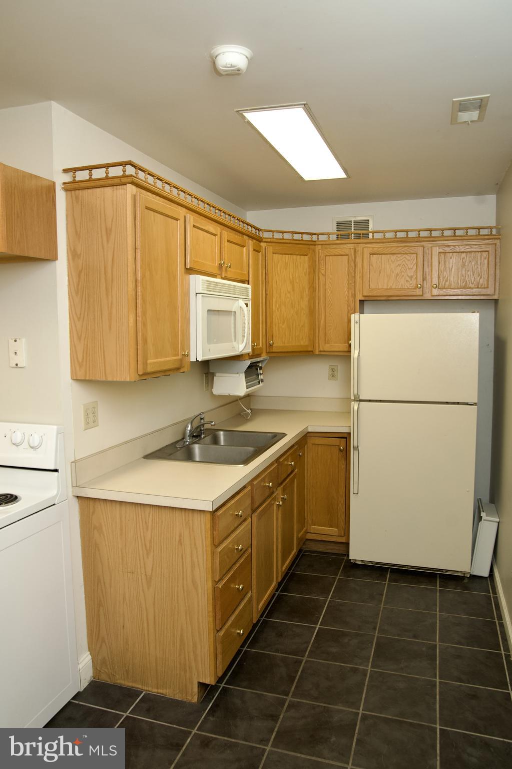 31867 Shavox Road Salisbury, MD 21804 - Photo 47 of 64 a kitchen with a sink a stove cabinets and a refrigerator