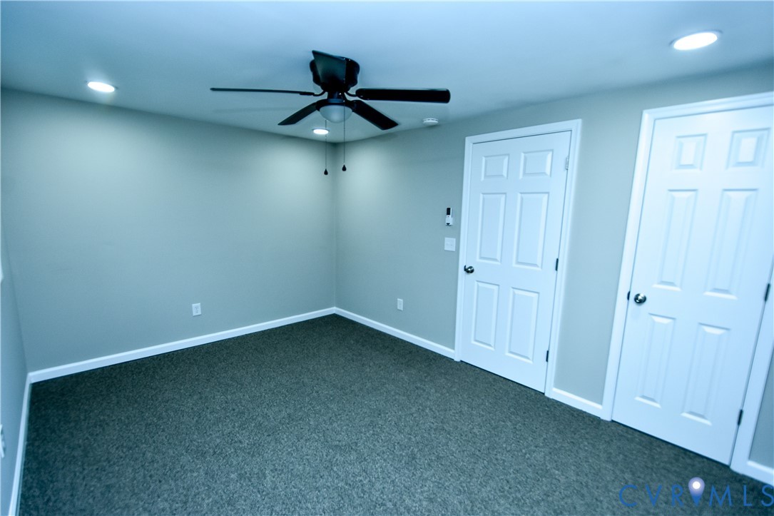416 South Virginia Street Farmville, VA 23901 - Photo 17 of 33 an empty room with a ceiling fan and carpet