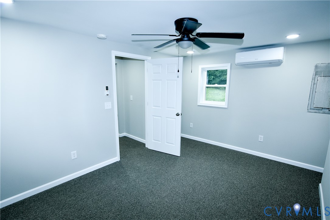 416 South Virginia Street Farmville, VA 23901 - Photo 21 of 33 an empty room with a ceiling fan and window