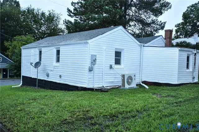 a view of a house with a yard and sitting area